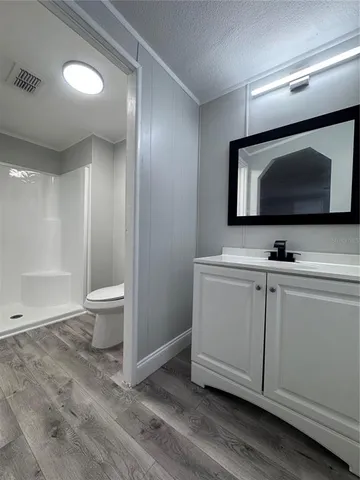 a bathroom with a sink a toilet and mirror