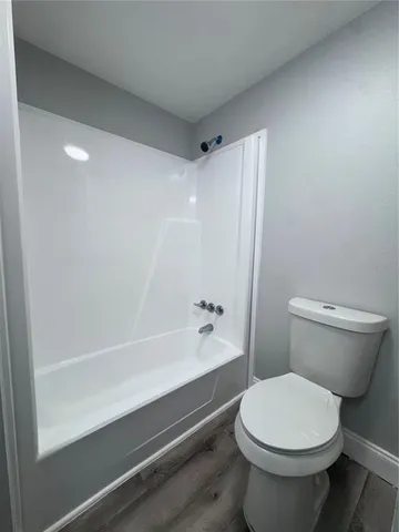 a bathroom with a toilet and a bathtub