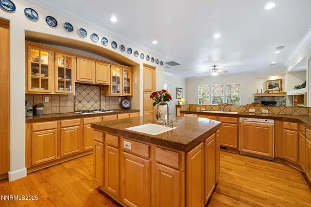 a kitchen with stainless steel appliances granite countertop a sink a stove and a refrigerator