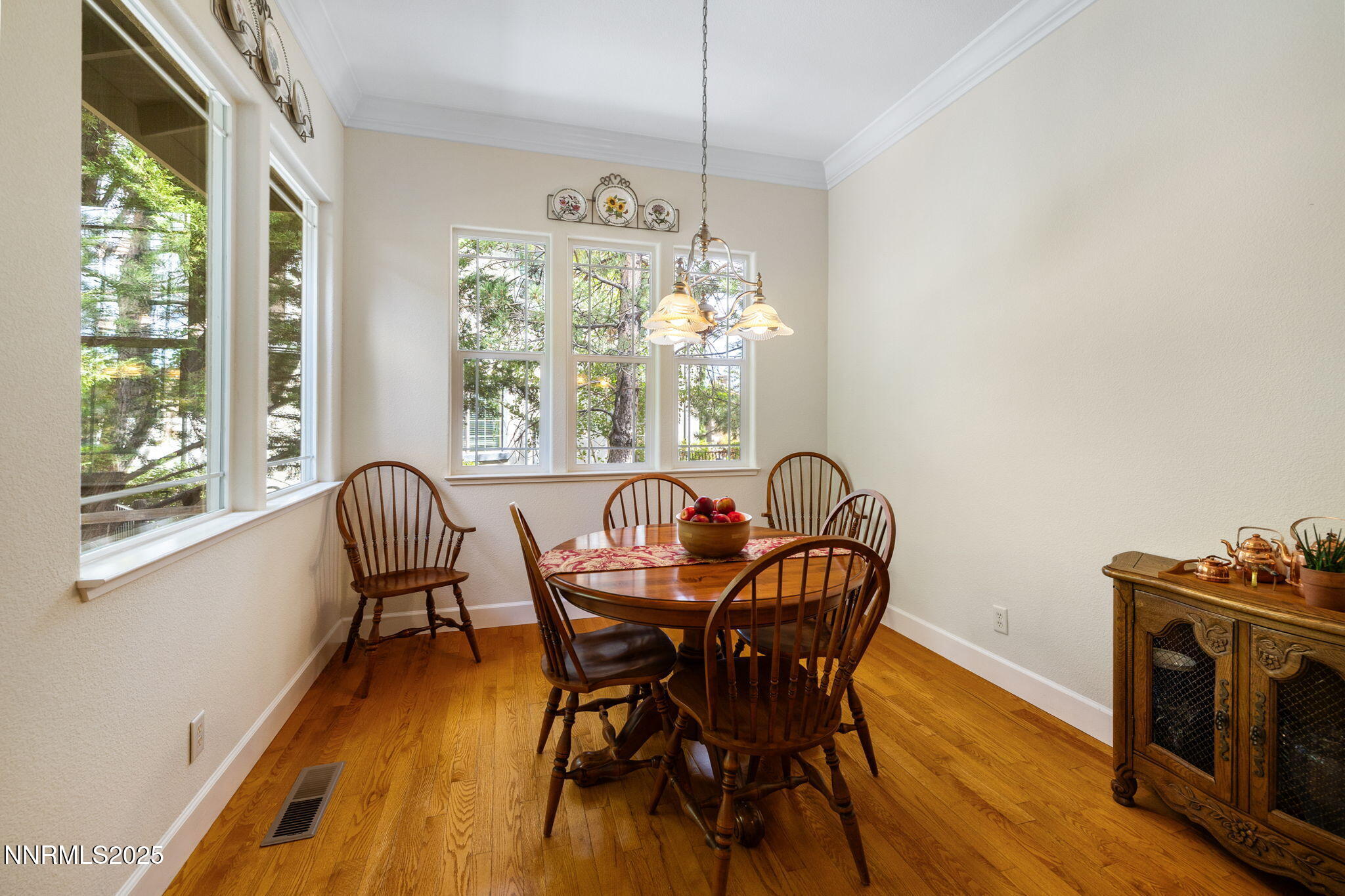 4865 Buckhaven Road Reno, NV 89519 - Photo 16 of 47 a dining room with furniture a chandelier and wooden floor