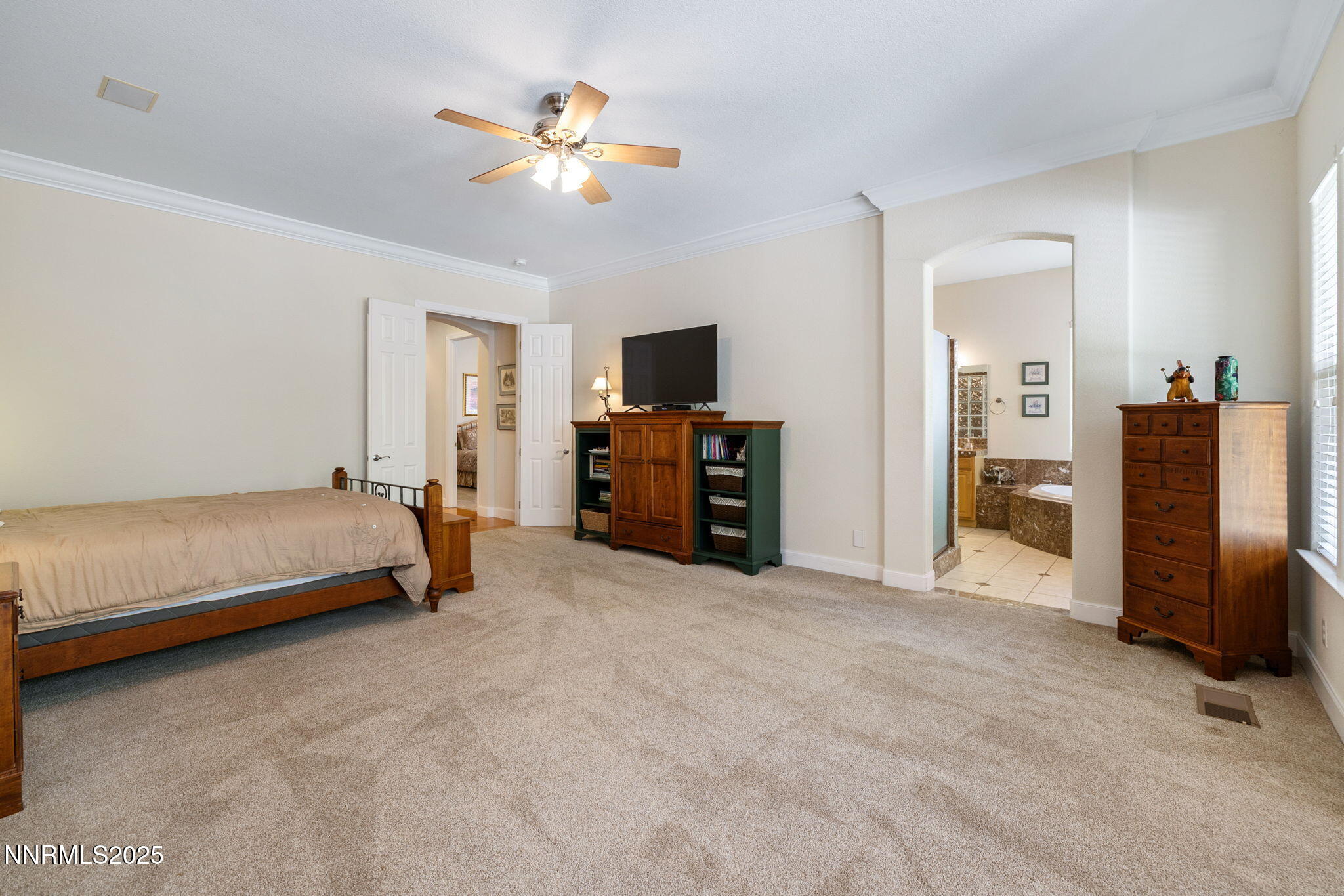 4865 Buckhaven Road Reno, NV 89519 - Photo 27 of 47 a spacious bedroom with a bed and a television