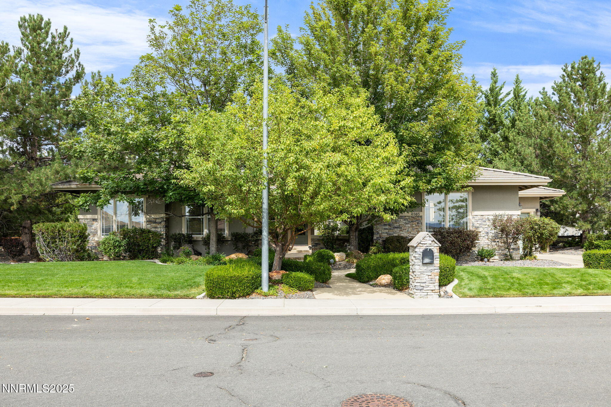 4865 Buckhaven Road Reno, NV 89519 - Photo 39 of 47 a front view of a house with a garden and trees