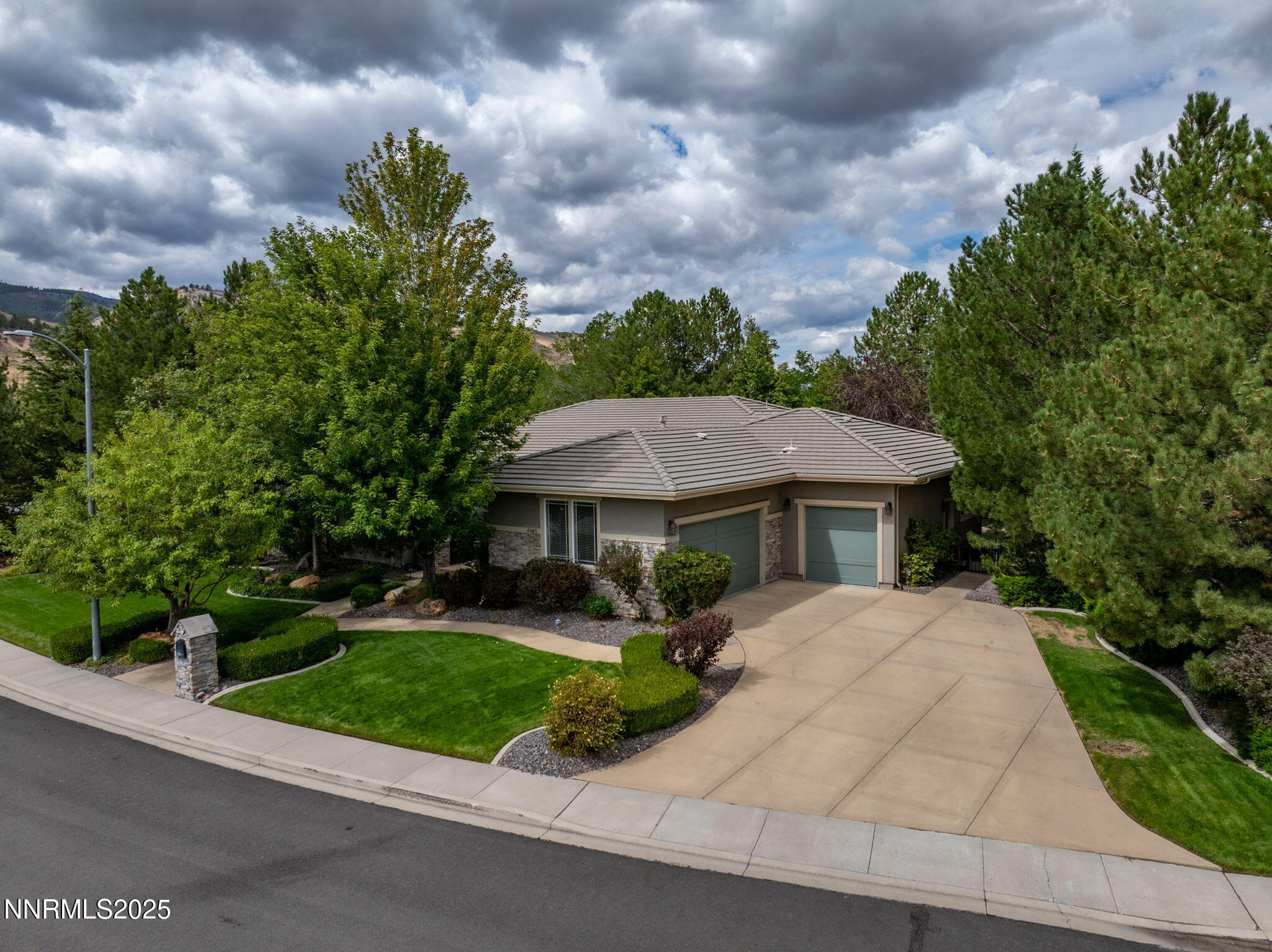 4865 Buckhaven Road Reno, NV 89519 - Photo 40 of 47 a front view of a house with a yard and potted plants