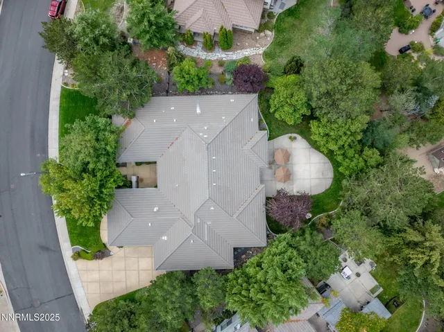 an aerial view of a house with a yard and outdoor seating