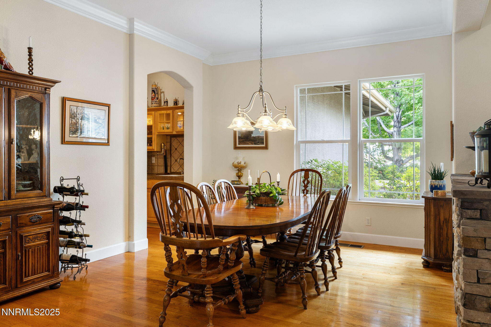 4865 Buckhaven Road Reno, NV 89519 - Photo 8 of 47 a dining room with furniture a chandelier and wooden floor