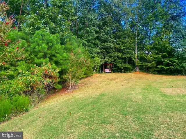 a large kitchen with stainless steel appliances granite countertop a lot of counter space and wooden floor
