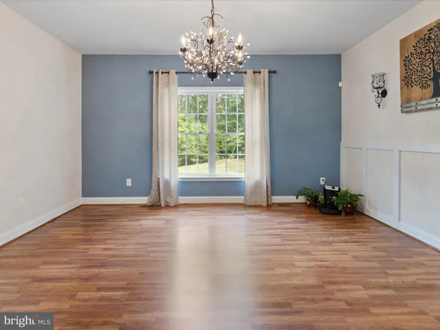 a kitchen with granite countertop a sink stove and refrigerator