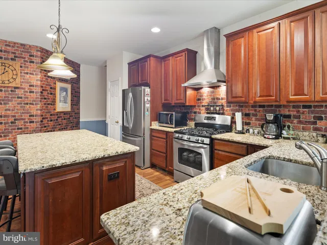 a bed sitting in a bedroom next to a window with a chandelier