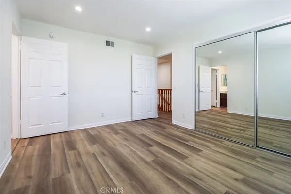 a view of a room with wooden floor and cabinet