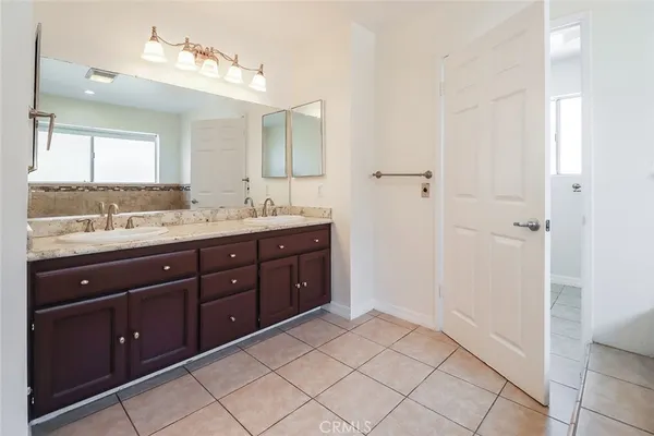 a spacious bathroom with a granite countertop sink a mirror and a