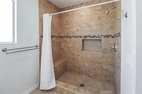 a bathroom with a glass shower door