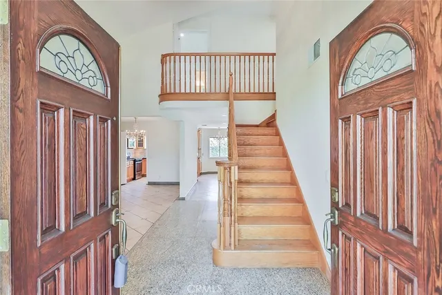 a view of a hallway with entryway wooden floor and front door