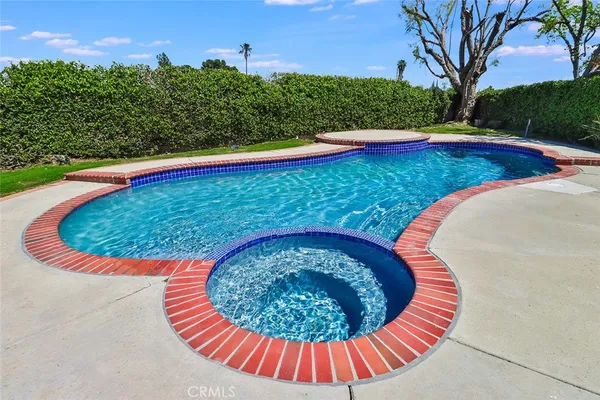 a view of a swimming pool with a yard