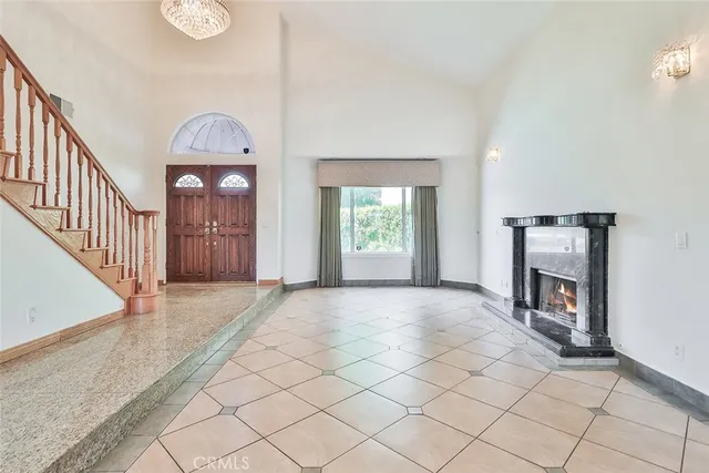 a view of a livingroom with a fireplace a window and a fireplace