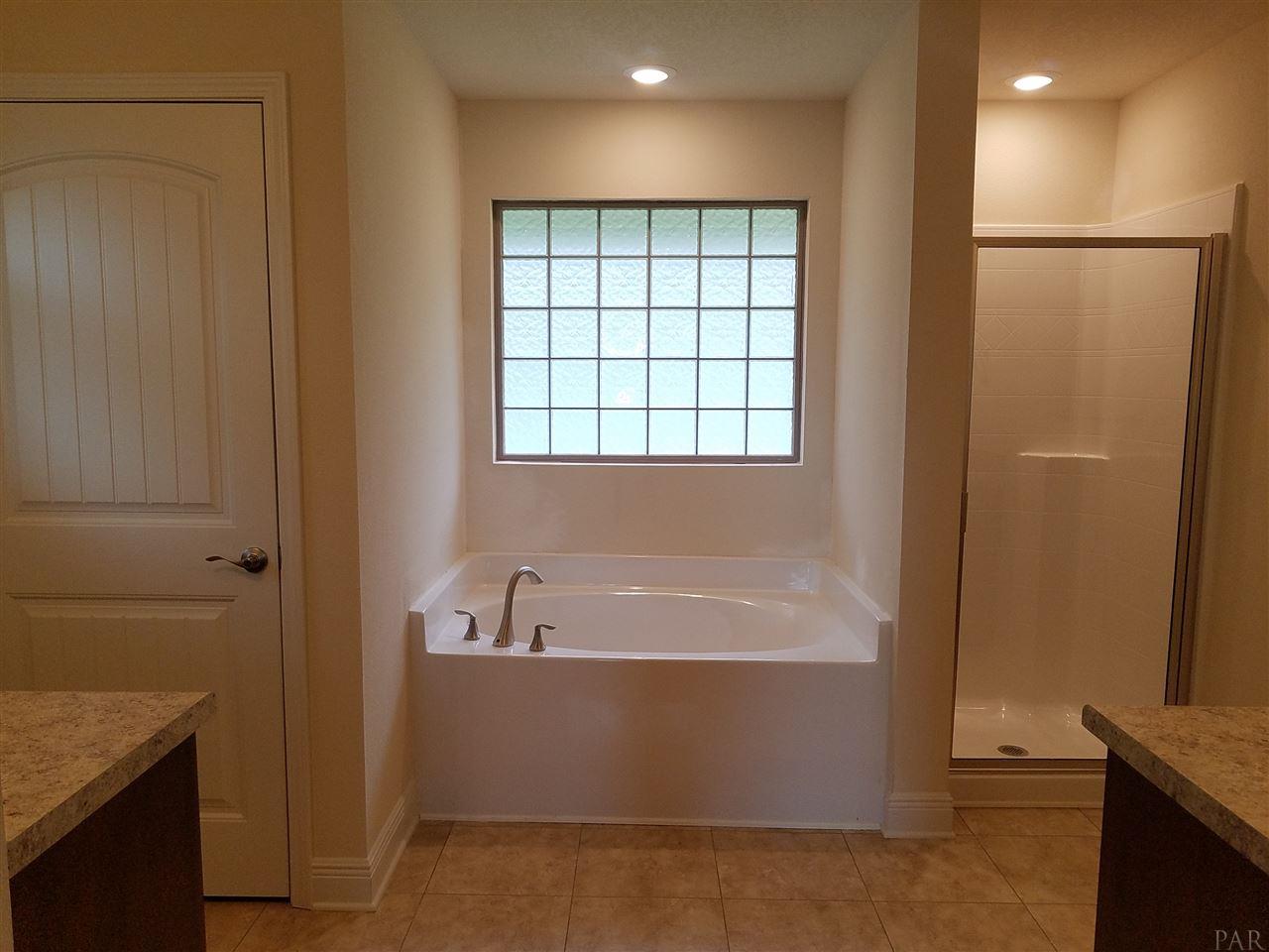1439 Promenade Loop Cantonment, FL 32533 - Photo 24 of 36 luxurious garden tub with block window
