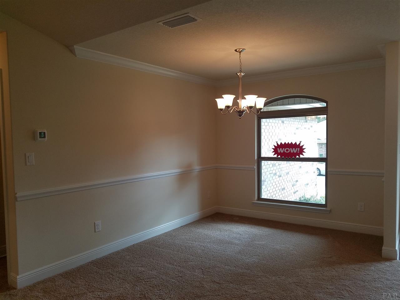 1439 Promenade Loop Cantonment, FL 32533 - Photo 8 of 36 Accented with Crown molding and chair rail detail
