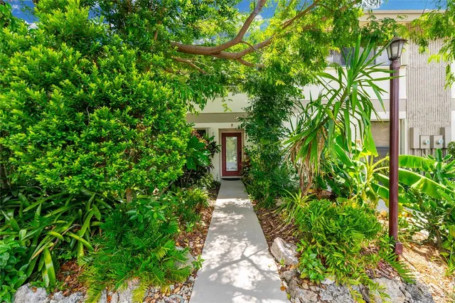 a front view of a house with lots of green space