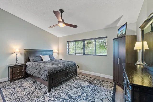 a bedroom with a bed and a mirror on the dresser