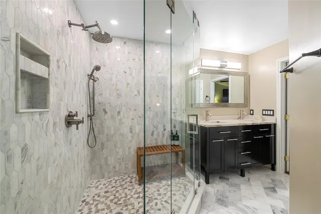 a spacious bathroom with a sink a toilet a mirror and shower