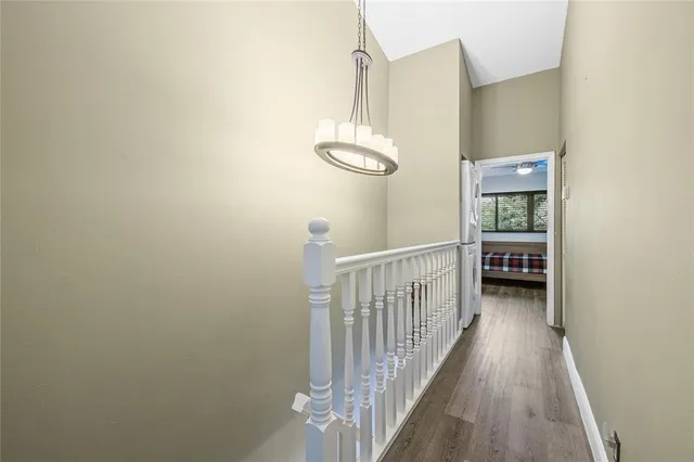 a view of a hallway with wooden floor and staircase