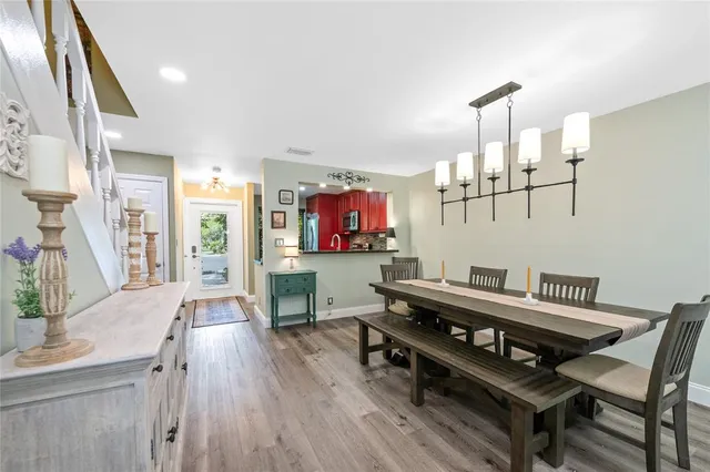 a living room with furniture a flat screen tv and kitchen view