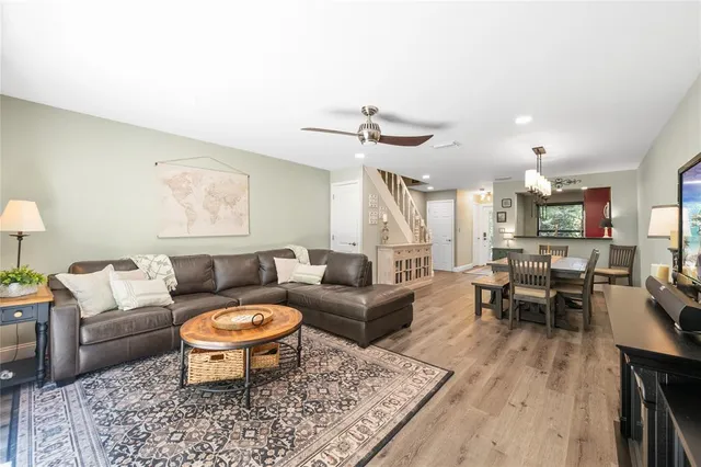 a living room with furniture a rug and a table