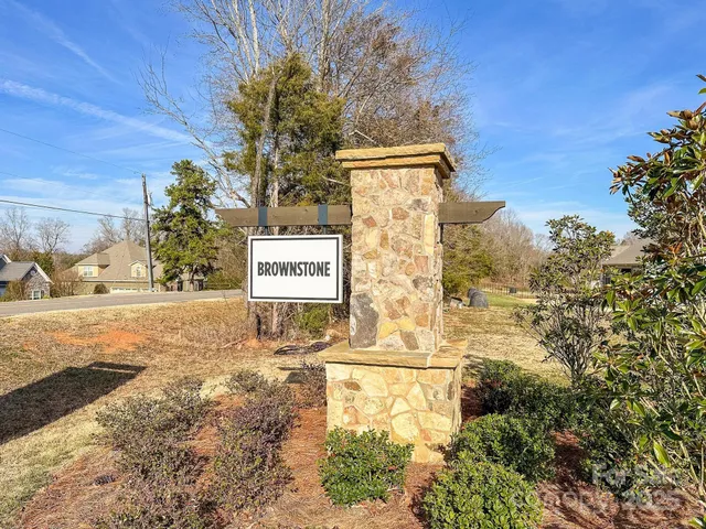 a view of a water fountain with large trees