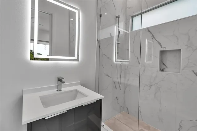 a bathroom with a sink toilet and shower