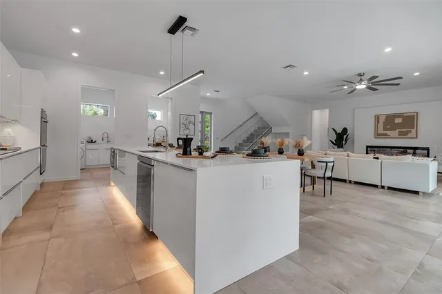 a kitchen with sink a stove and cabinets