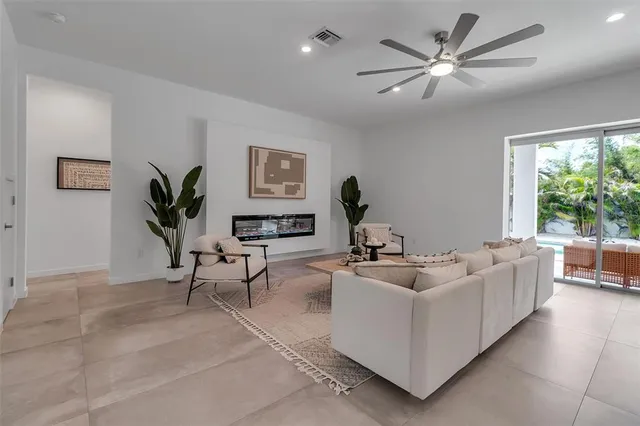 a living room with furniture and kitchen view
