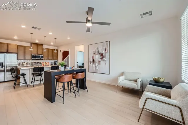 a living room with furniture kitchen and a table