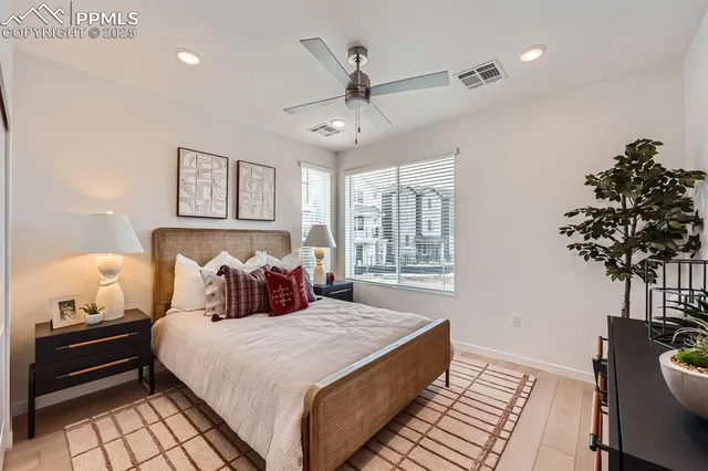 a bedroom with a bed and a potted plant