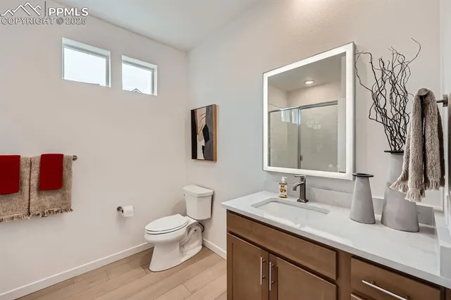 a bathroom with a toilet a sink and mirror