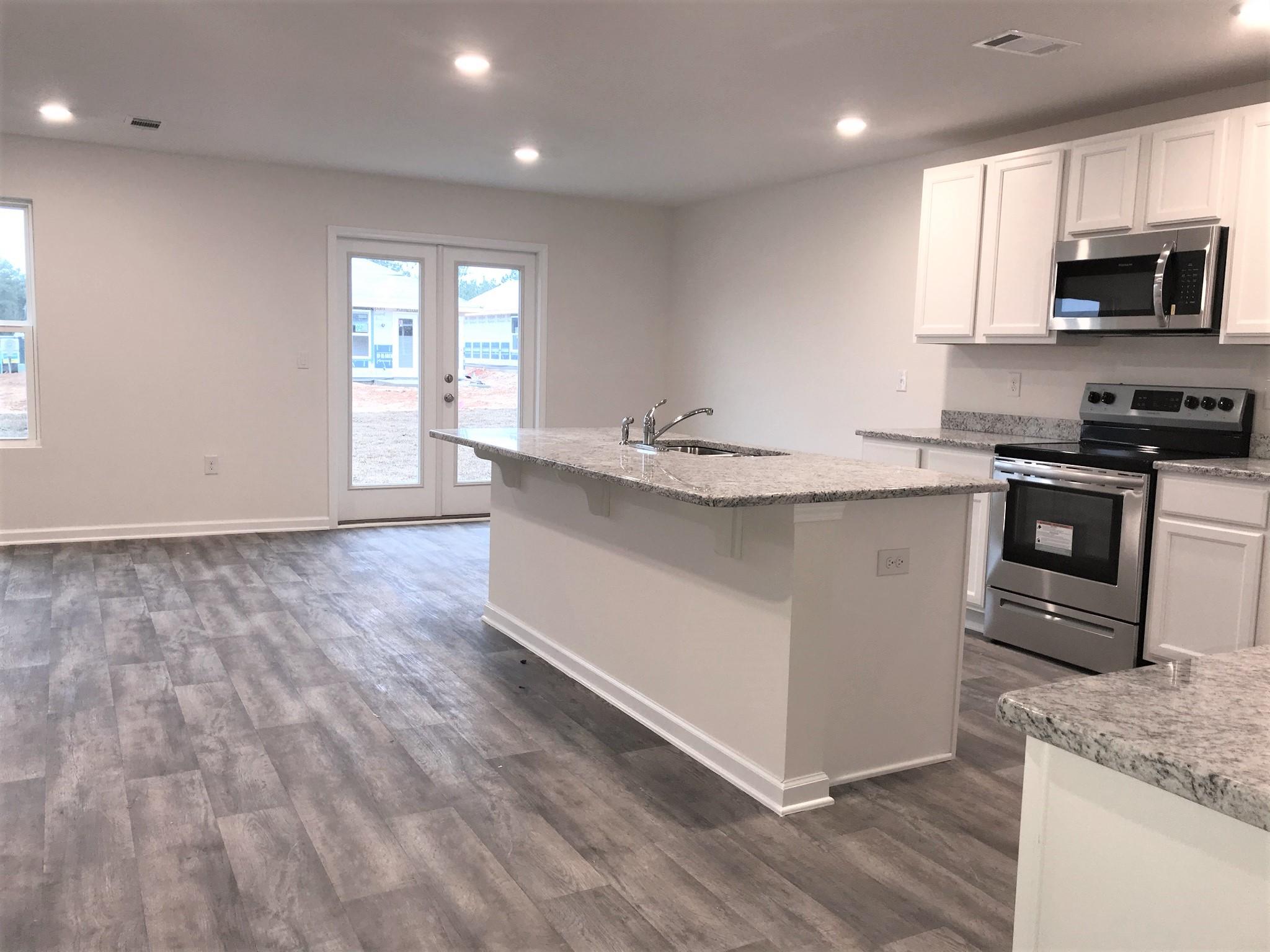 320 Flounder Street Crestview, FL 32539 - Photo 6 of 18 a kitchen with stainless steel appliances granite countertop a sink a stove a microwave a sink and cabinets