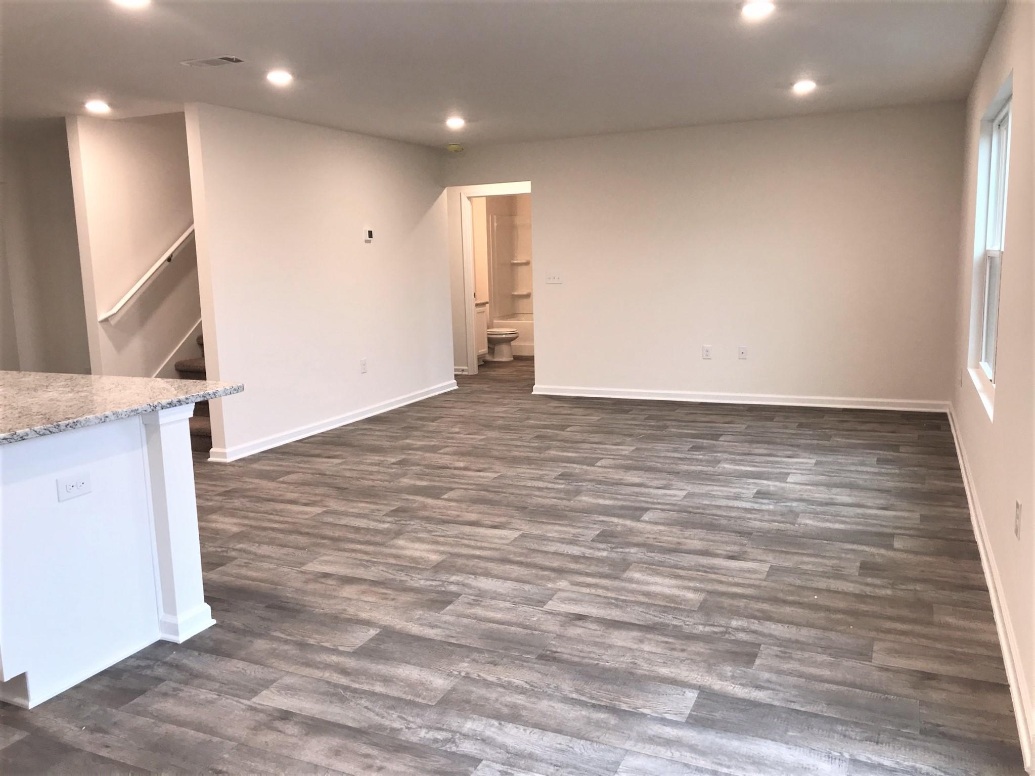 320 Flounder Street Crestview, FL 32539 - Photo 7 of 18 a view of a livingroom with wooden floor and staircase