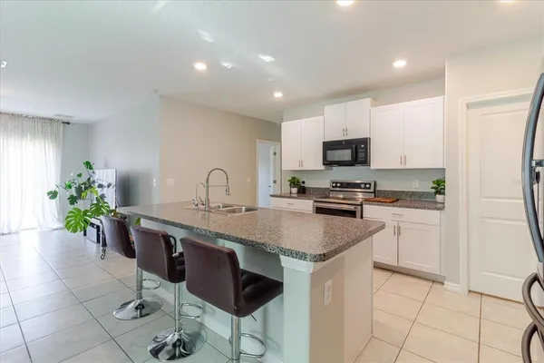 a kitchen with a stove and a white cabinets