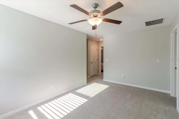 a bedroom with a bed and ceiling fan