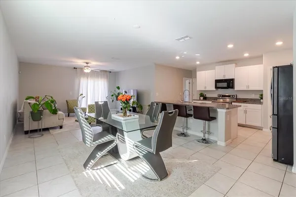 a living room with furniture and a chandelier