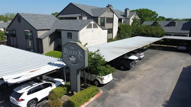 an aerial view of a house with swimming pool and porch