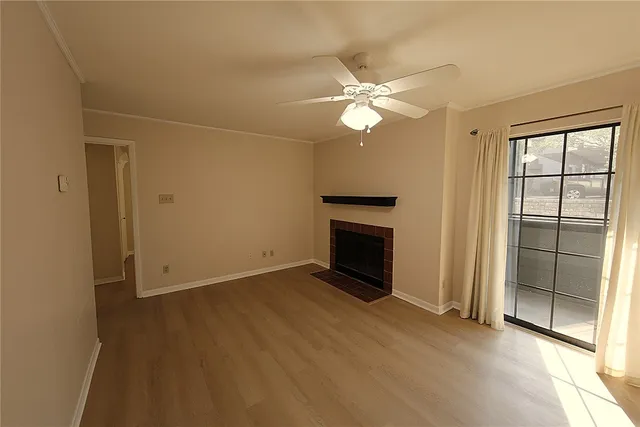 wooden floor in an empty room with a fireplace