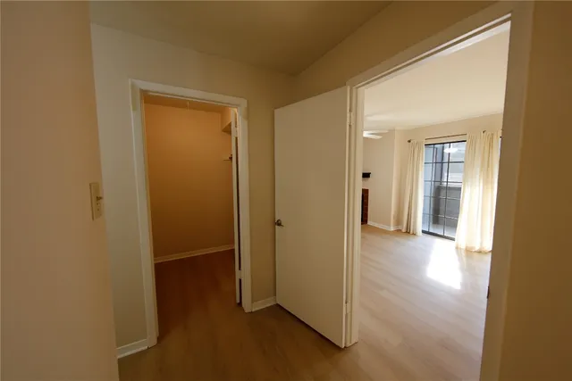 a view of a hallway with wooden floor