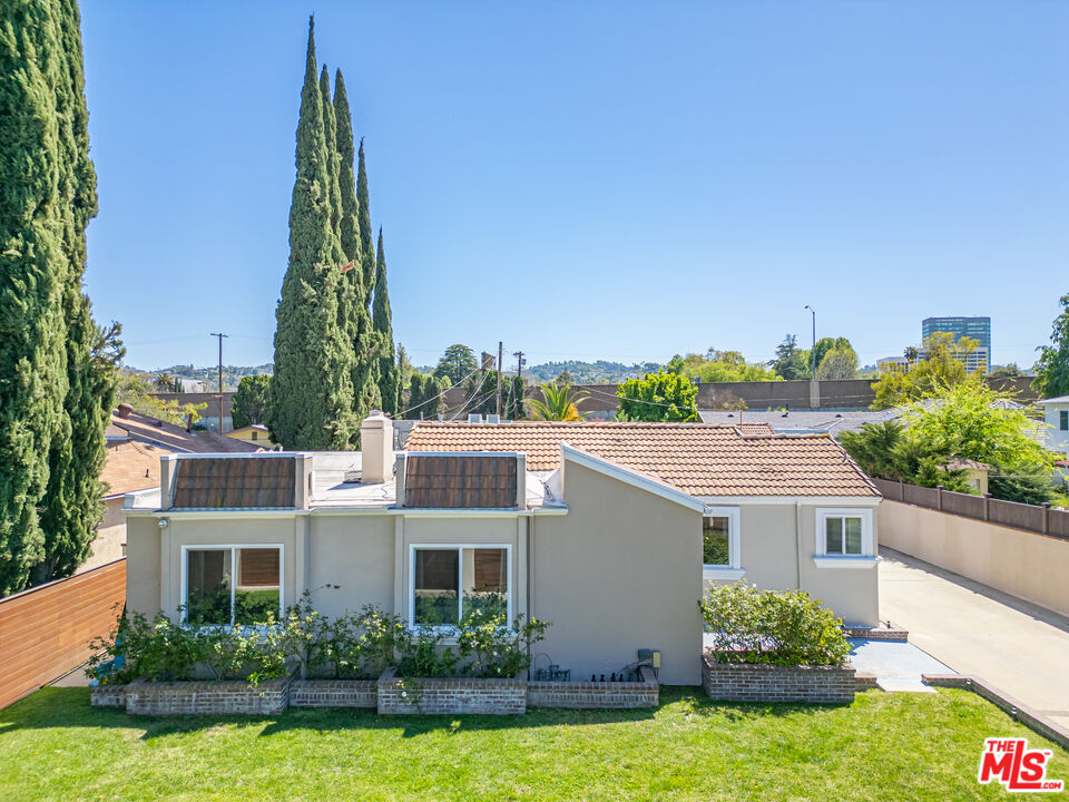 15042 Valleyheart Drive Sherman Oaks, CA 91403 - Photo 1 of 31 a view of a house with a yard and potted plants