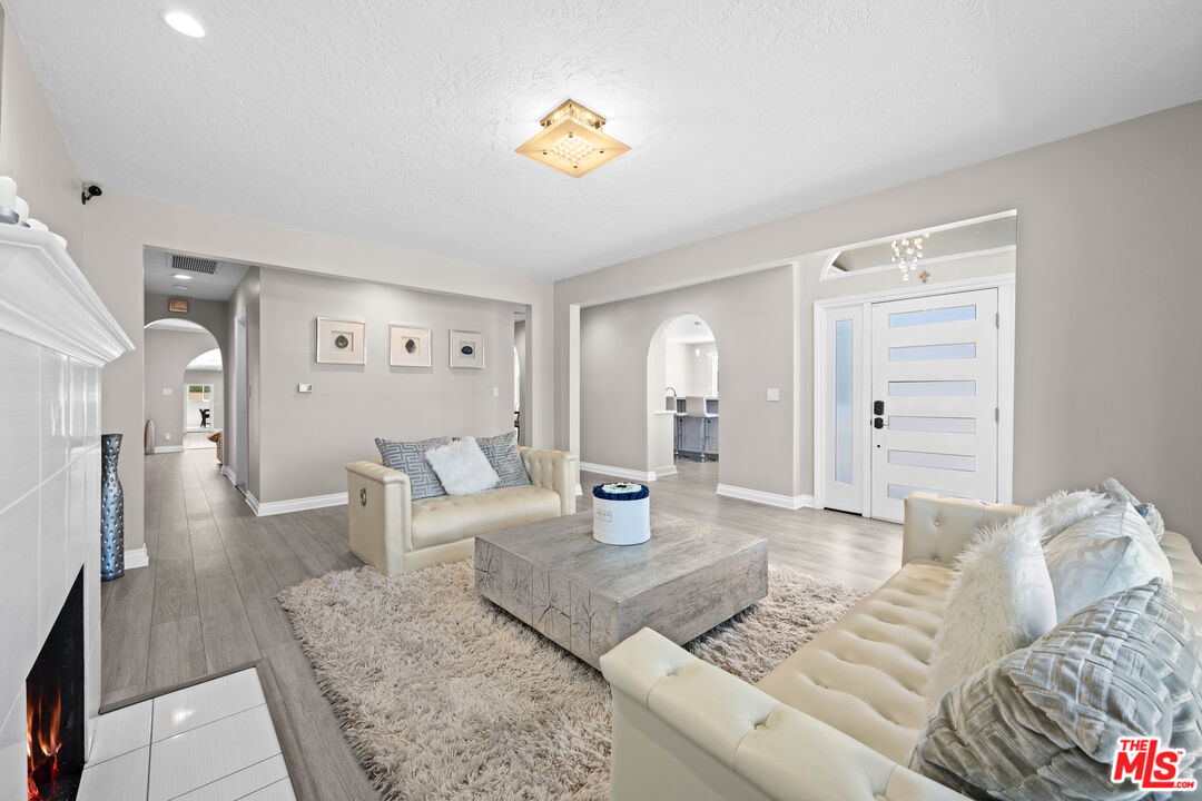 15042 Valleyheart Drive Sherman Oaks, CA 91403 - Photo 11 of 31 a bedroom with furniture and a chandelier