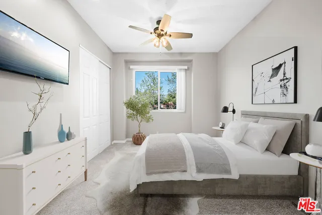 a bedroom with a large bed and a window