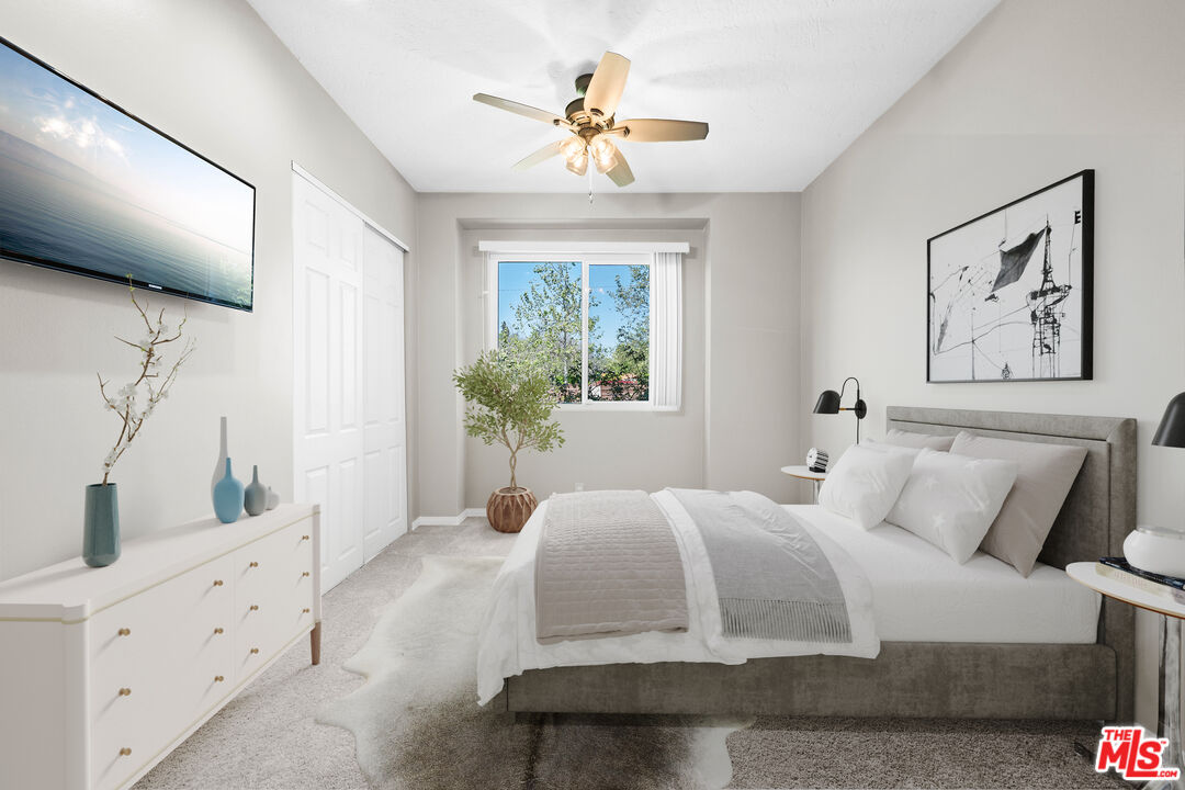 15042 Valleyheart Drive Sherman Oaks, CA 91403 - Photo 12 of 31 a bedroom with a large bed and a window