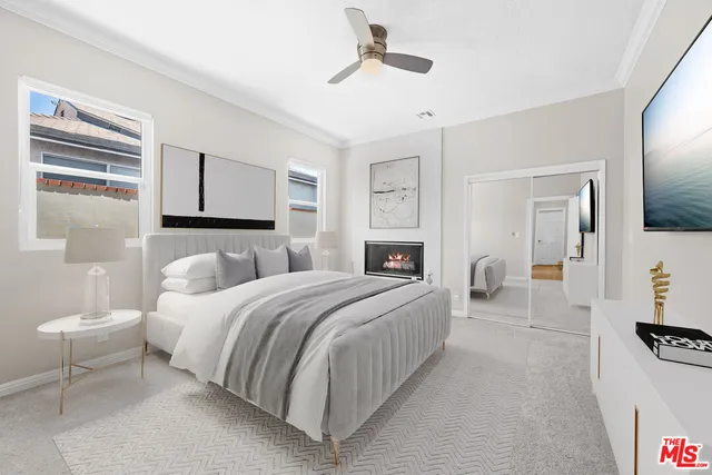 a bedroom with a bed couch and a window