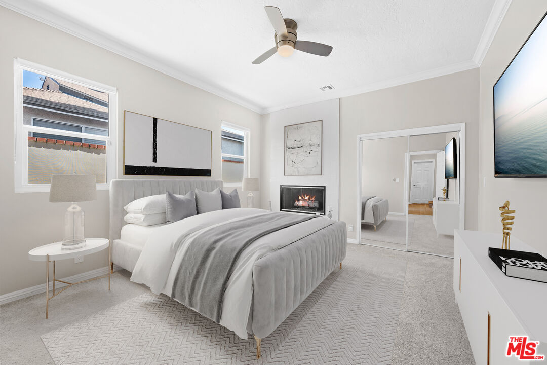 15042 Valleyheart Drive Sherman Oaks, CA 91403 - Photo 13 of 31 a bedroom with a bed couch and a window