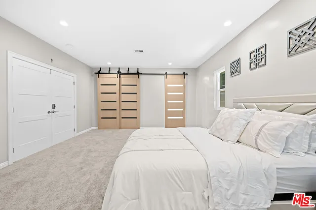 a bedroom with a bed and a closet
