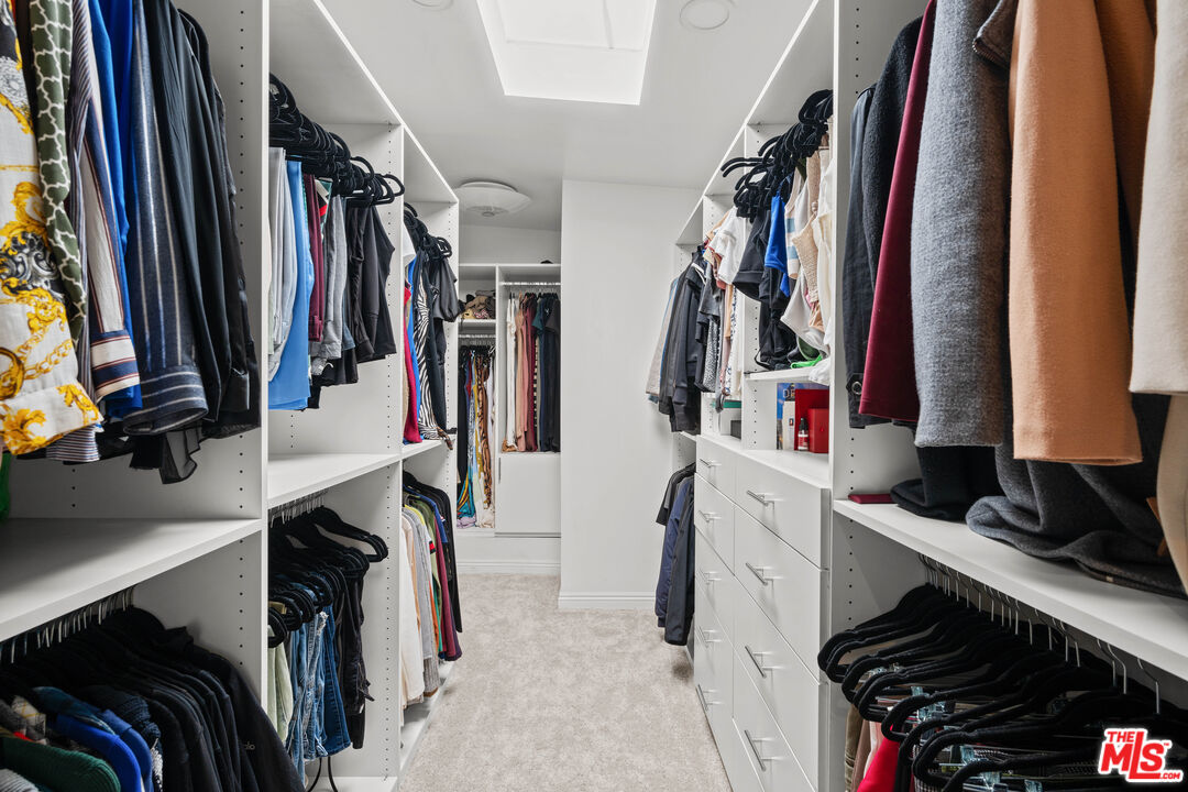 15042 Valleyheart Drive Sherman Oaks, CA 91403 - Photo 19 of 31 a view of walk in closet with clothes and shoes