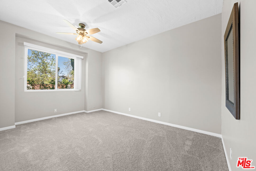 15042 Valleyheart Drive Sherman Oaks, CA 91403 - Photo 21 of 31 an empty room with windows and fan